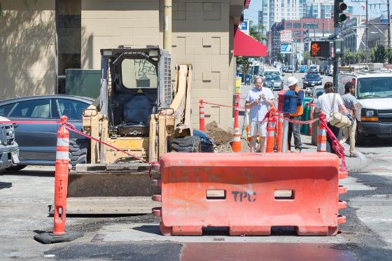 Construction crew working on street trenching and utility upgrades for Central Subway project on 4th Street.