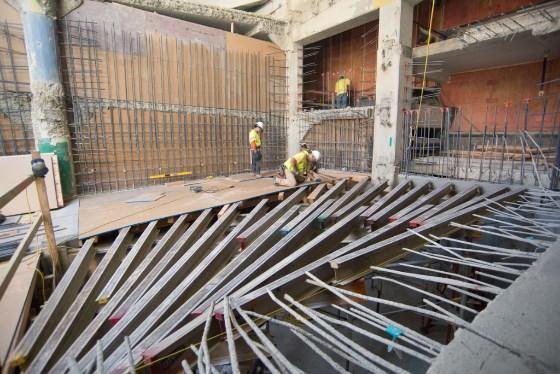 Construction workers install rebar and forms for Central Subway station ramp at Union Square.