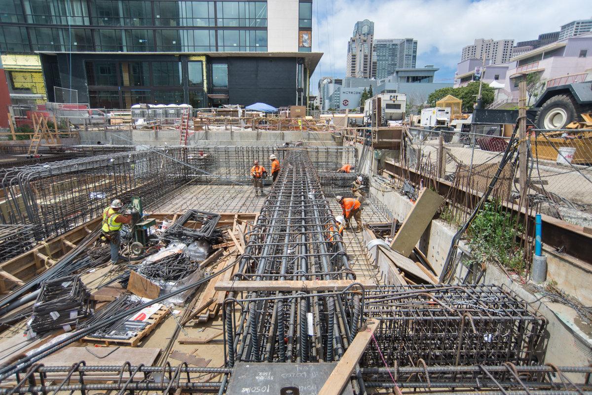 Construction workers assemble steel rebar reinforcement for Central Subway station foundation in downtown San Francisco.