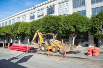 Construction equipment and materials staged on 4th Street near Brannan for utility work.