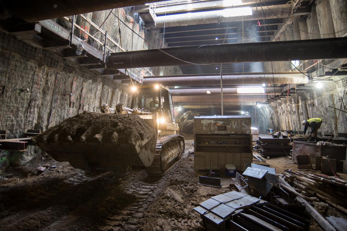 Construction equipment and excavation work inside underground transit station box at Stockton Street.