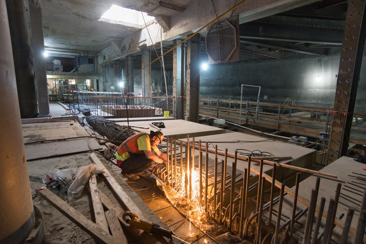 Worker welding rebar inside Union Square/Market Street Station north concourse during construction.
