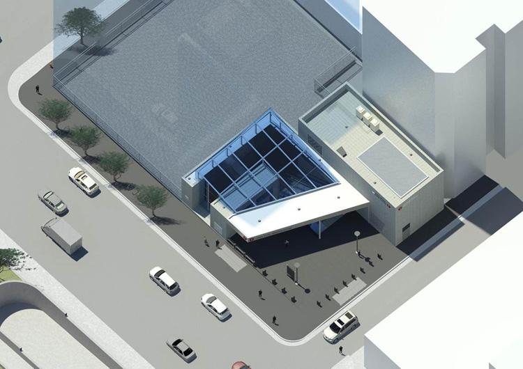 Aerial view of Yerba Buena/Moscone Station with blue canopy, plaza, parked cars, and pedestrians.
