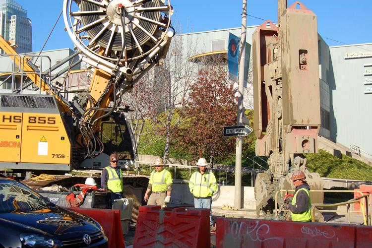 Construction crew operates concrete pump truck on 4th Street between Howard and Folsom streets.