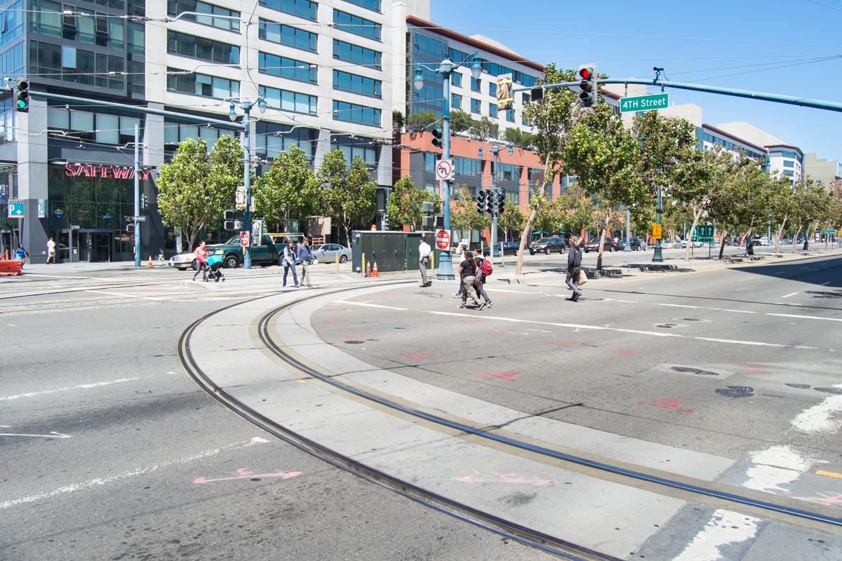 Intersection of 4th and King Streets showing exposed streetcar tracks during Central Subway construction in San Francisco.