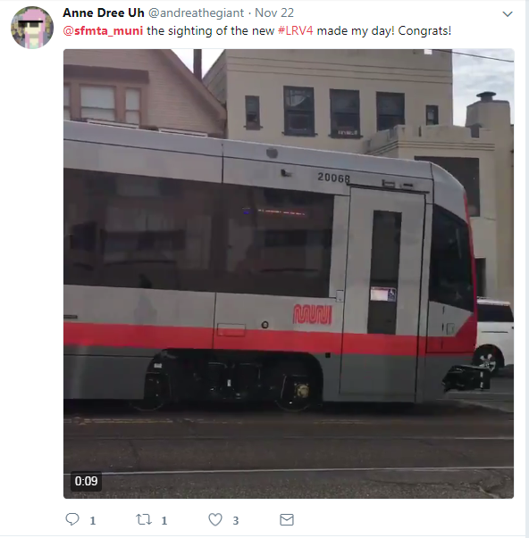 New LRV4 train car 2006 on city street with buildings in background.