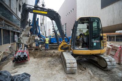Construction equipment operating on Stockton Street for transit project pile installation work.