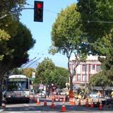 Bus stop closure on Columbus Avenue with construction barriers and traffic signal visible.