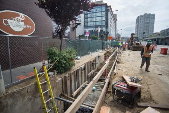 Construction workers install sewer line on 4th Street near Central Subway project site.