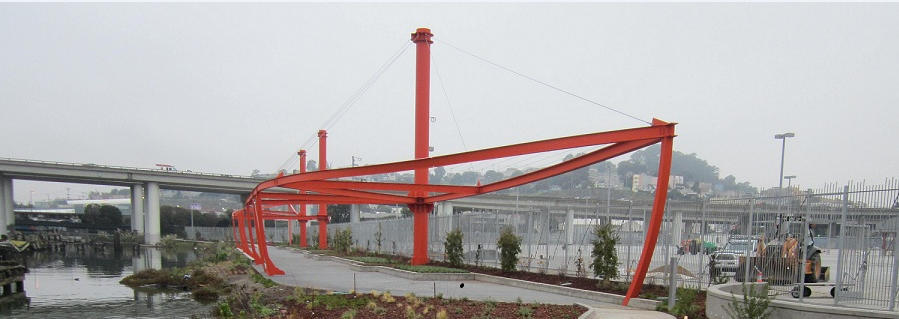 Red steel frame structure with glass panels at Shoreline Park, featuring industrial architecture and waterfront setting.