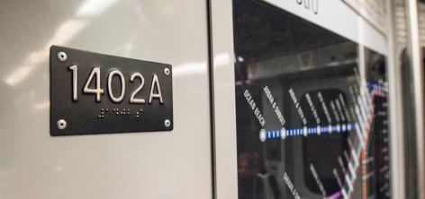 Bus 1402A with tactile number plate in Braille and raised characters mounted on exterior.