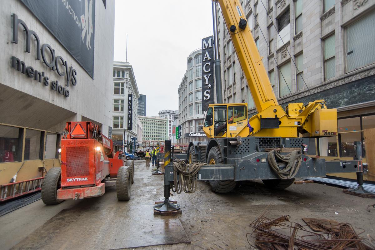Construction equipment and materials at Stockton and O'Farrell Streets downtown, including yellow crane and red machinery.