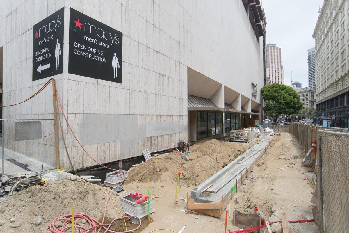 Construction site at Stockton and O'Farrell with excavation, fencing, and Macy's Men's Store signage visible.