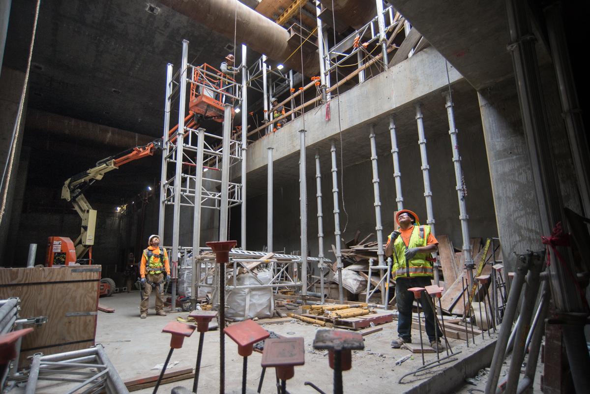 Construction workers in safety gear inside Yerba Buena/Moscone Station during Central Subway project work.