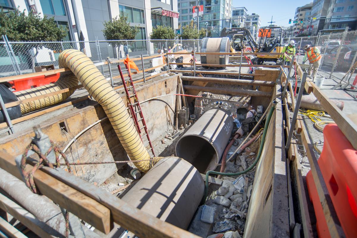 Construction site with large fiberglass pipes and equipment on 4th Street between King and Townsend.