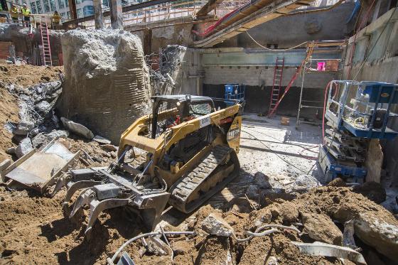 Tracked loader moving debris during Central Subway construction on 4th Street, San Francisco.