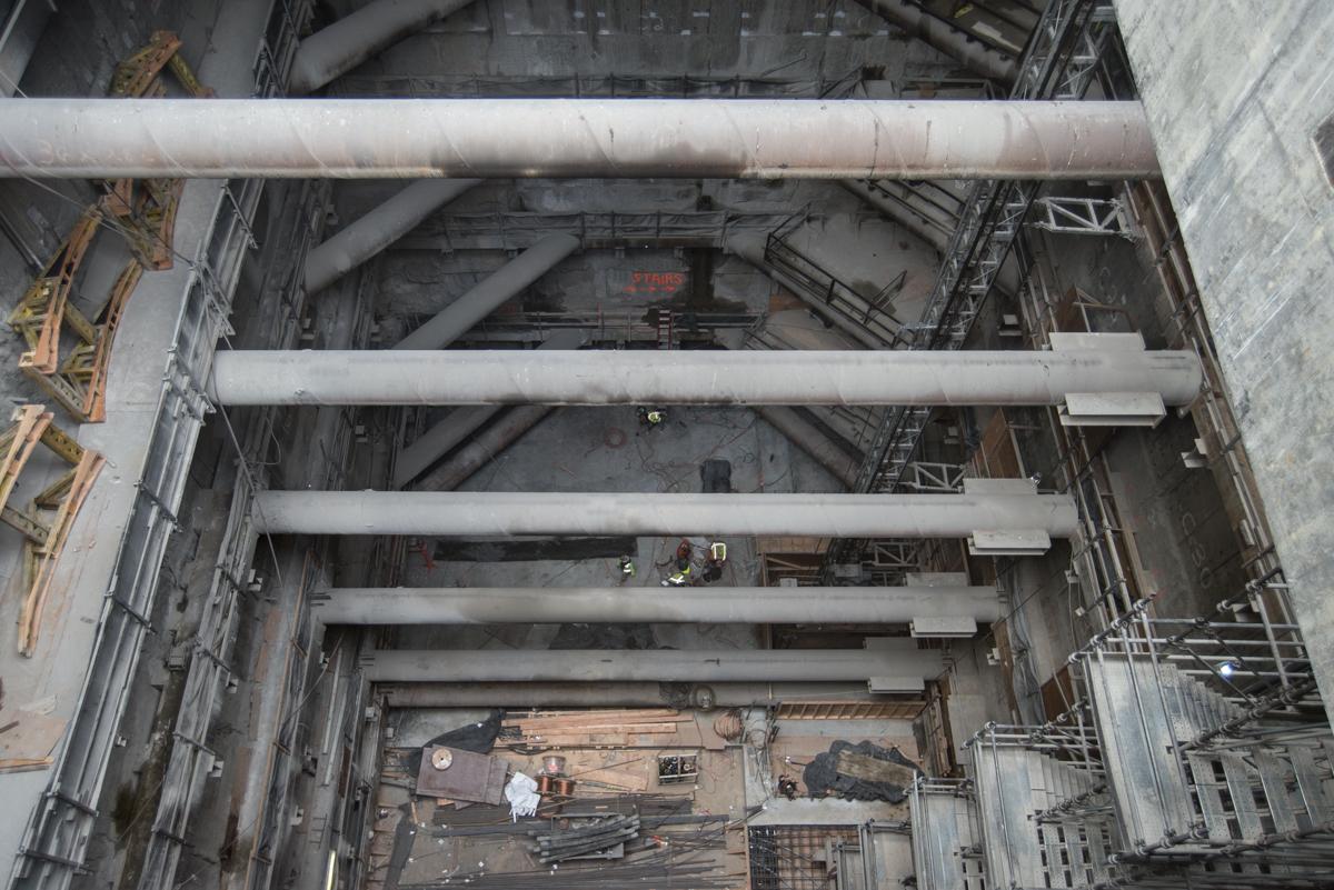 Concrete beams and temporary cross-bracing inside Chinatown Station headhouse under construction.