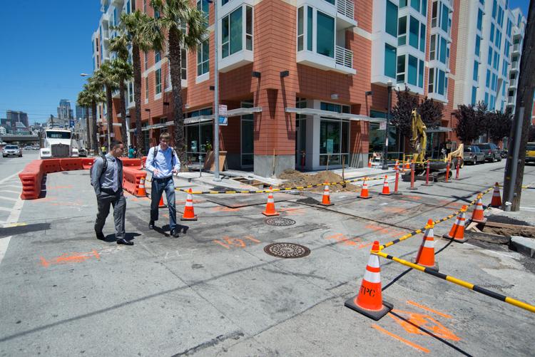 Construction work at 4th Street and Freelon Alley in SoMa with utility relocation equipment and safety barriers.
