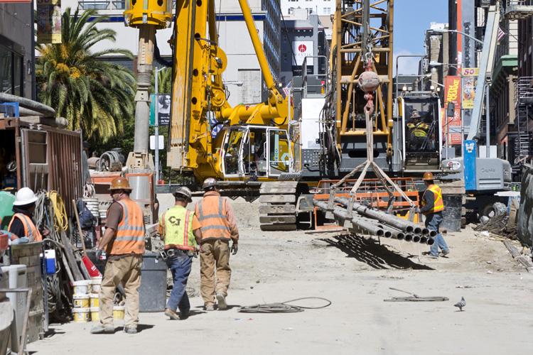 Construction crew operates heavy machinery on Stockton Street for future Union Square/Market Street Station.