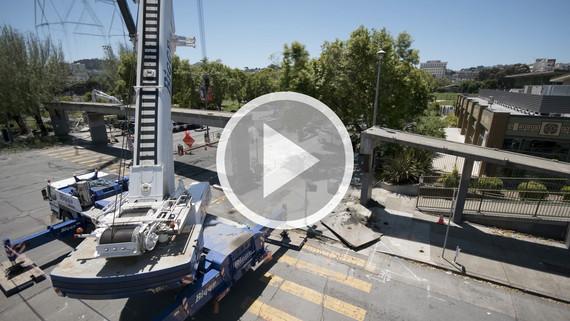 Steiner Bridge demolition site with crane and construction equipment over waterway.