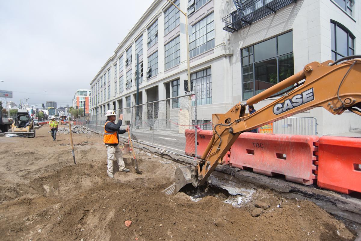 Construction crew excavating utilities at 4th and Bluxome for Central Subway track foundation work.