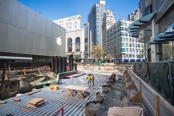 Construction site at 4th and Market Street with steel decking, scaffolding, and urban buildings in background.