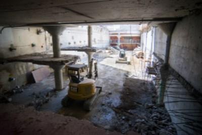Union Square Garage interior showing demolition work, exposed concrete structure, and construction equipment.