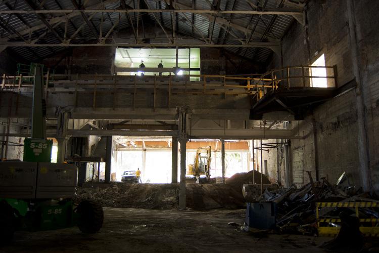Interior of Chinatown Stockton Street station under construction with demolition equipment and debris visible.