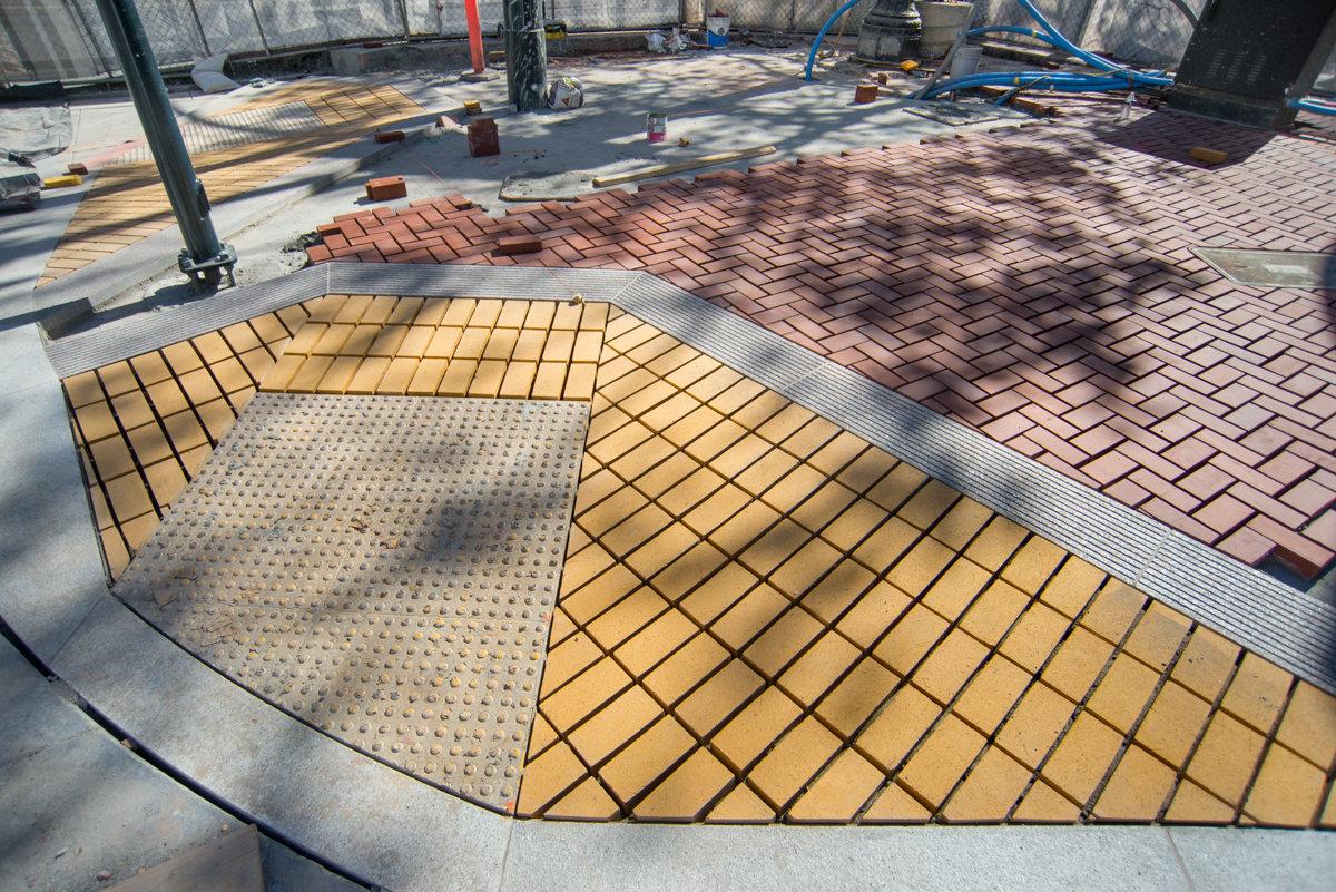 Newly laid brick and stone paving on Ellis Street during transit station construction work.
