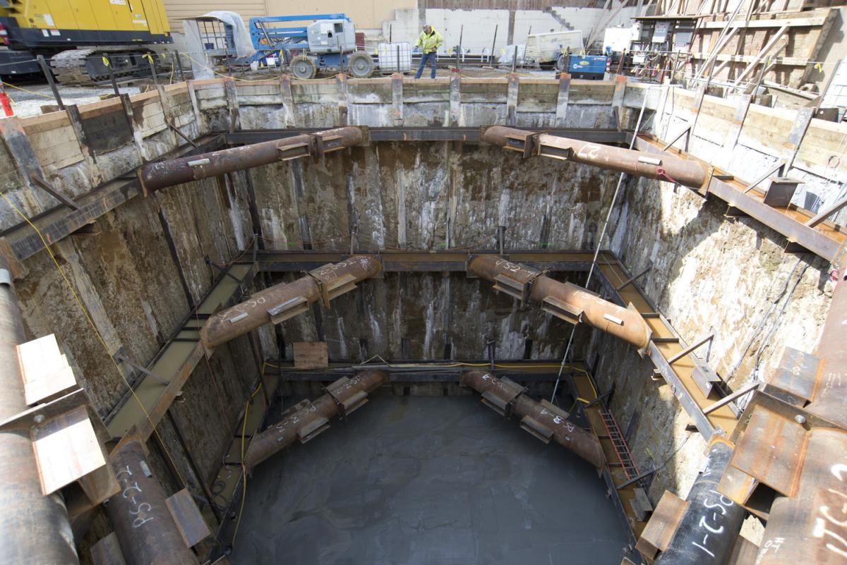 TBM retrieval shaft interior showing concrete floor and support structures at construction site.