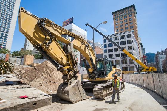 CAT excavator demolishes Union Square Garage for Central Subway construction in downtown San Francisco.