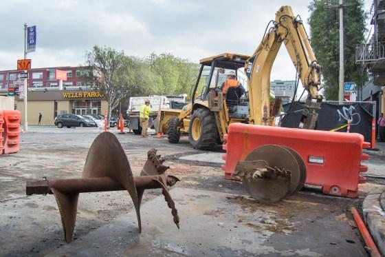 Construction equipment and auger bits at Central Subway project work site on 4th Street.