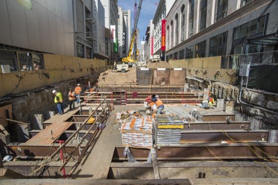 Construction workers on Stockton Street building mezzanine level roof deck for Union Square/Market Street Station.