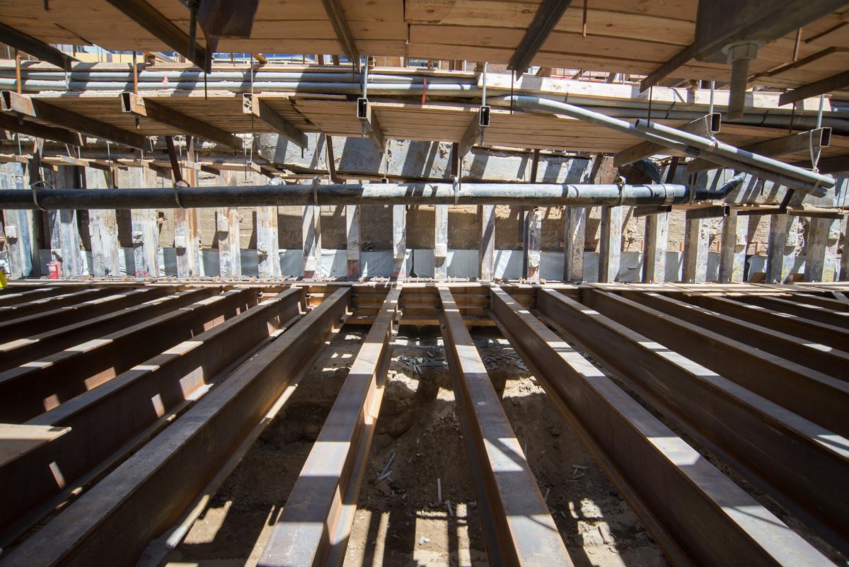Steel roof beams under construction at Union Square transit project, viewed from below.