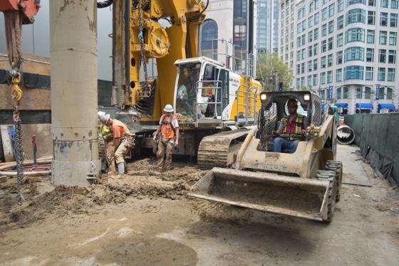 Construction crew operating heavy equipment to drive piles into ground on Ellis Street in downtown San Francisco.