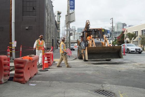 Construction workers and equipment on Welsh Street at 4th Street during sewer manhole installation work.