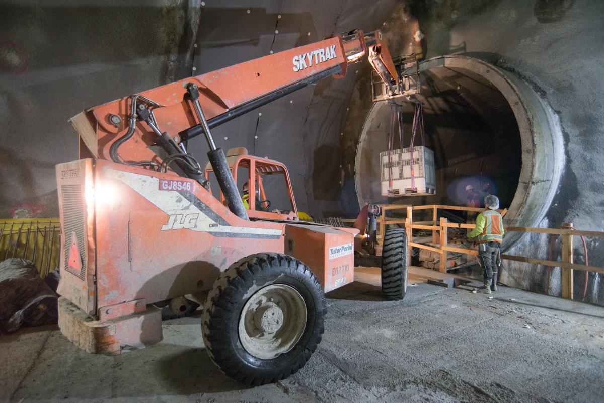 Skytrak telehandler lifting supplies into northbound tunnel at Chinatown Station construction site.