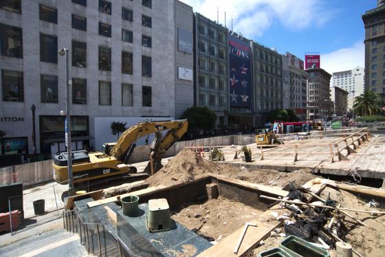 Construction excavation at Union Square Garage with yellow machinery and demolished debris on 4th Street.