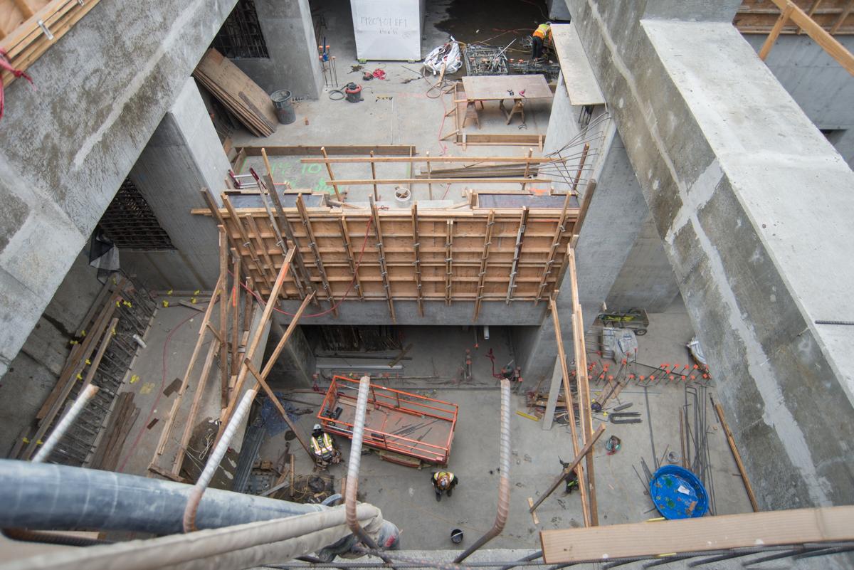 Aerial view of construction site showing wooden formwork and steel reinforcement inside concrete structure pit.