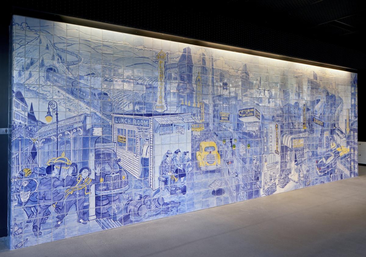 Large blue and white tile mural depicting vintage San Francisco cityscape with jazz-era imagery and architectural landmarks.