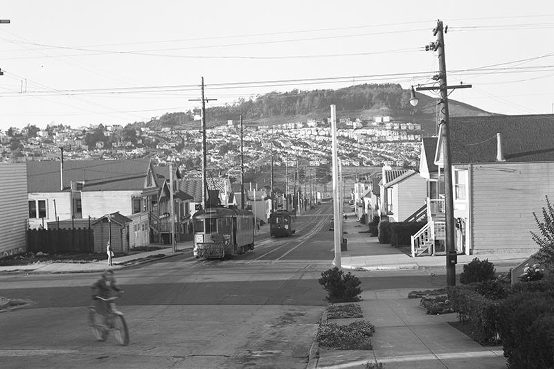 neighborhood at brighton & grafton aves with streetcars and kid on a bike