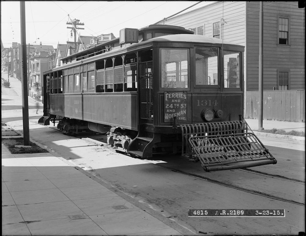 streetcar on street with houses in background