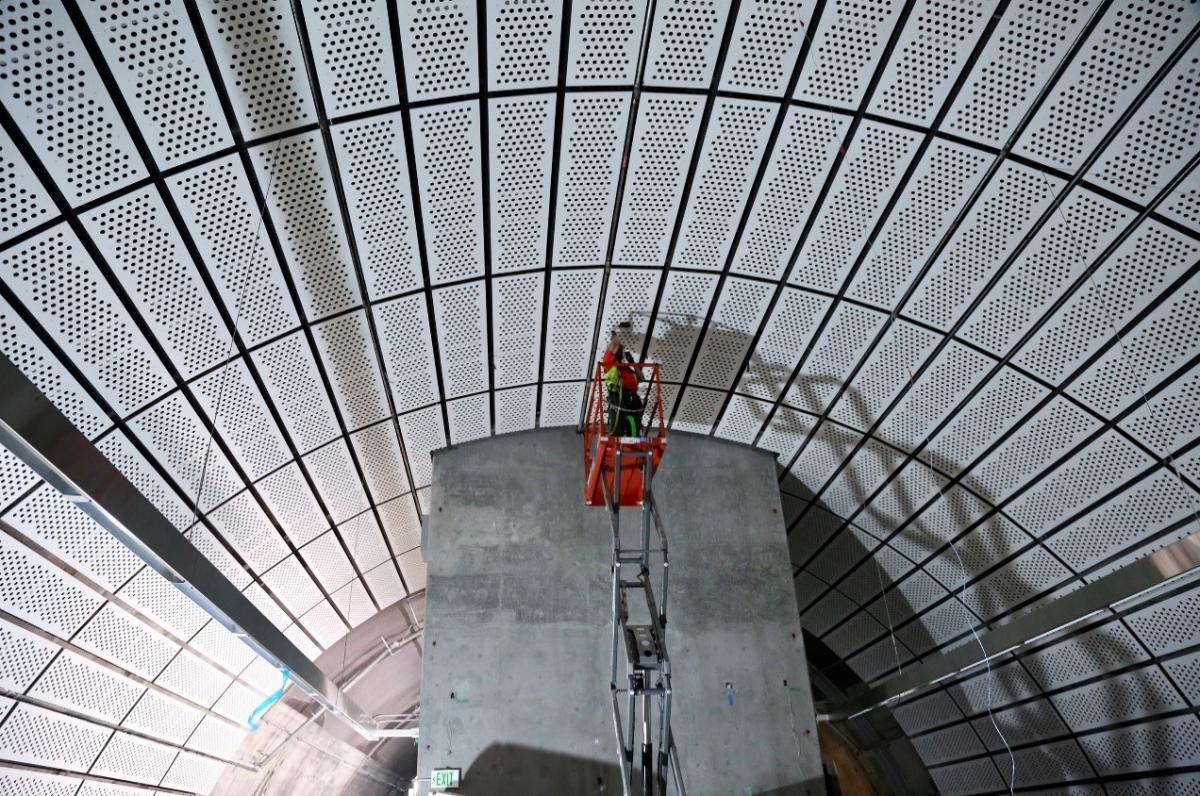 Some of the final decorative panels being installed at the platform level in Chinatown–Rose Pak Station 