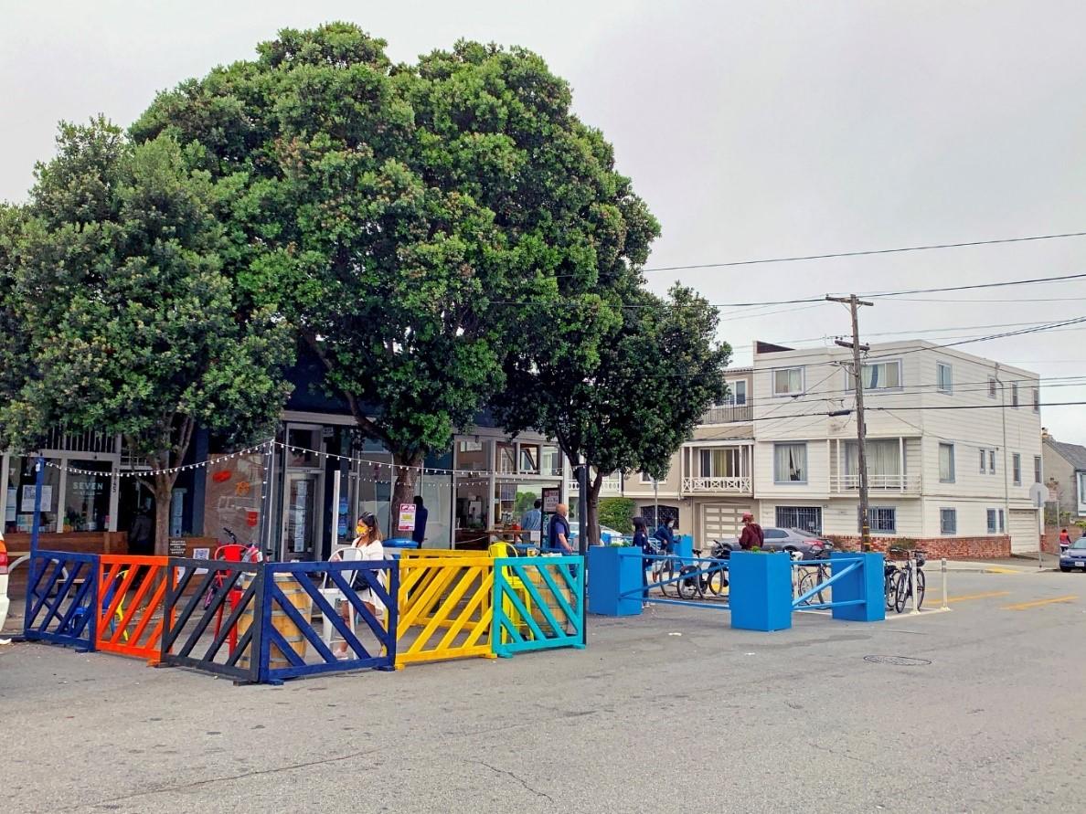 A picture of Seven Still's outdoor dining space with tables and chairs in a former parking space