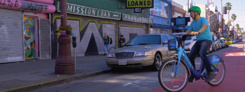 Bicycle crossing transit lane to reach the curb