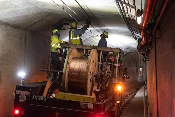Photo of crew installing overhead wire in the subway tunnel