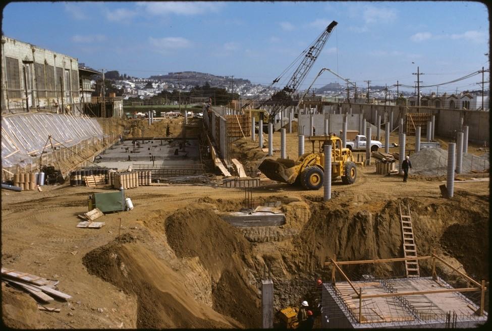 This 1976 photo shows major excavation and concrete work underway for the main shops building of Green Division.&nbsp; At far left is Elkton Shops built in 1907 by the United Railroads Company.