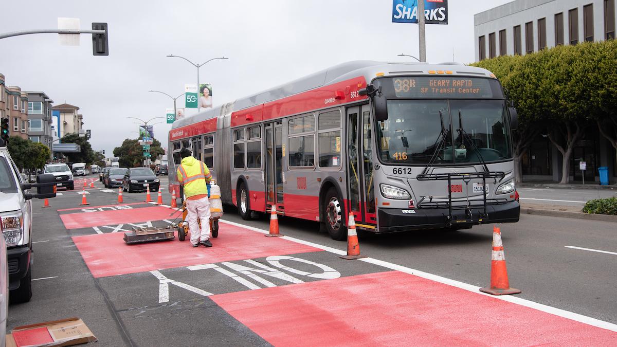 Photo of crew striping street with red paint on Geary