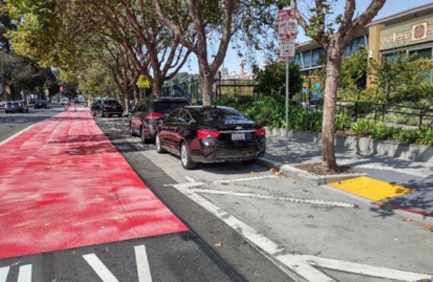 Photo: Crews install new red thermoplastic coloring in the outbound transit lane on Geary near Hamilton Recreation Center at Steiner Street
