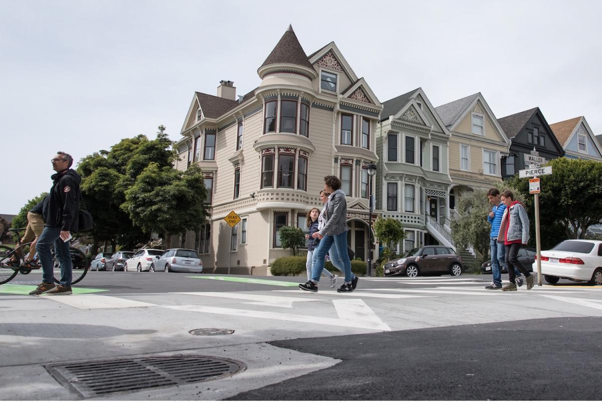 Pedestrians use a raised crosswalk at Pierce and Waller streets